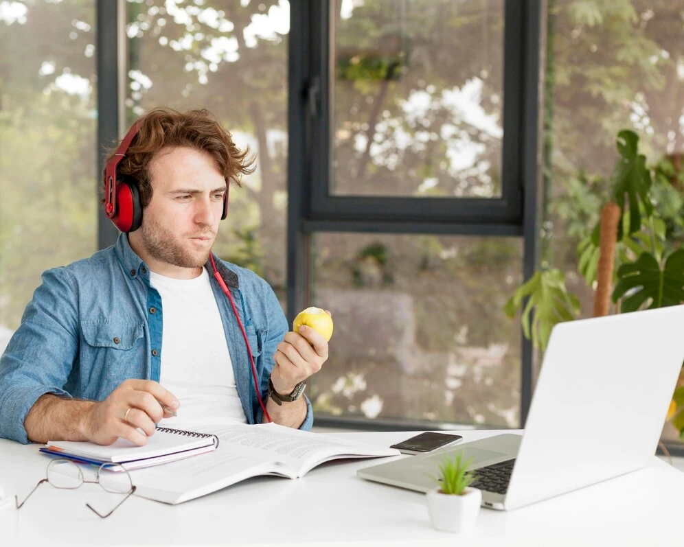 musician working on finances with laptop and headphones