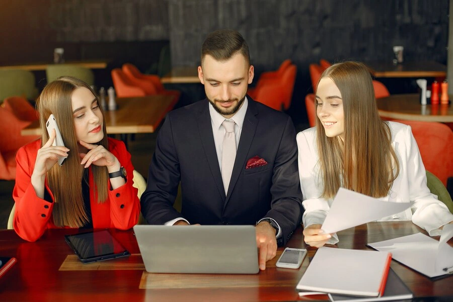 professionals discussing royalty management and financial documents