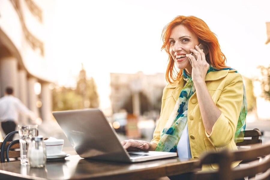 musician managing finances outdoors on laptop