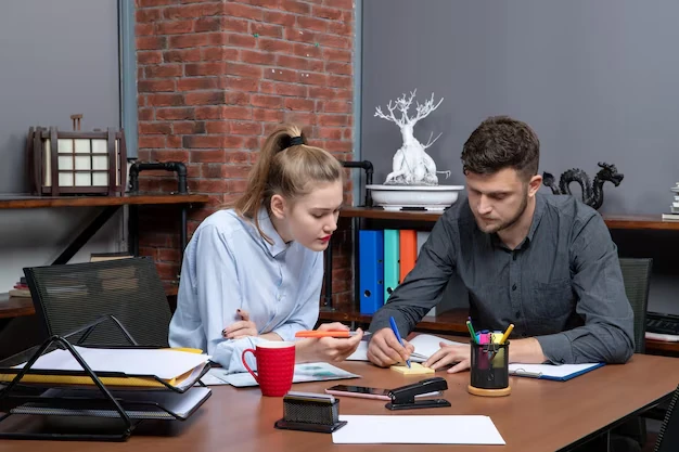 Accounting services for writers, represented by a clean, organized desk with a laptop, notepad, and plants, symbolizing efficiency and financial management.