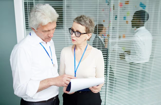 two professionals reviewing payroll documents