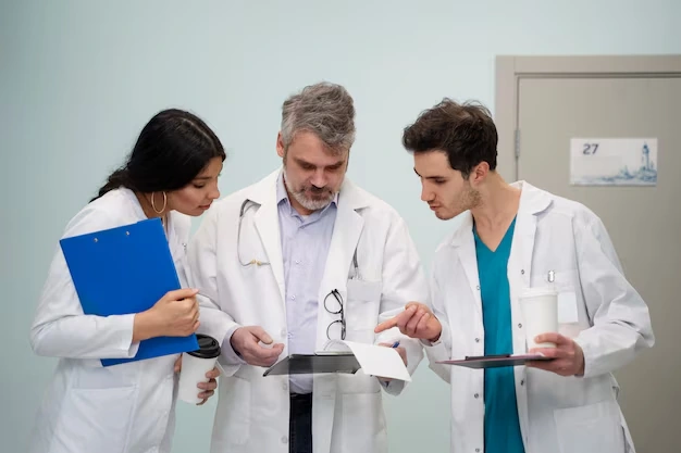 doctors reviewing financial documents on tablet